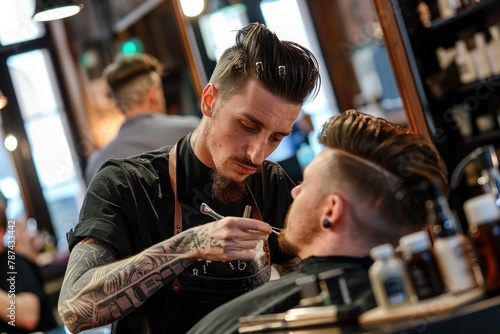 A tattooed barber is carefully using a straight razor to shape a male client's hairline in a vibrant barber shop setting