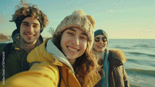 Happy smiling young people taking selfie against sea background, beach holiday with friends © pundapanda