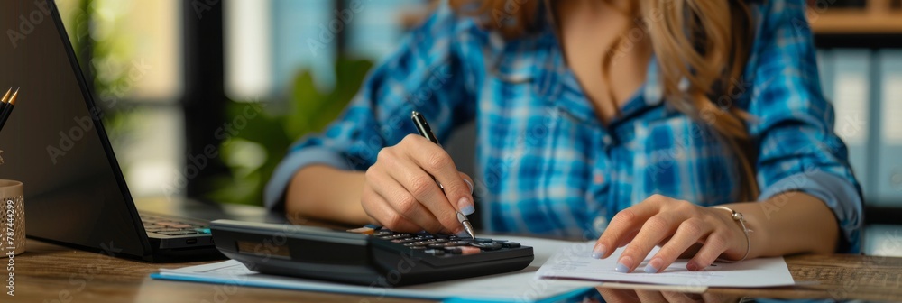 Obraz premium A female is seated at a desk using a cell phone and a calculator among office supplies and writing instruments accessories, banner