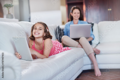Girl, child and tablet with mother and laptop, relax with technology for streaming subscription and internet at family house. Woman, working from home and daughter with gaming or elearning with smile