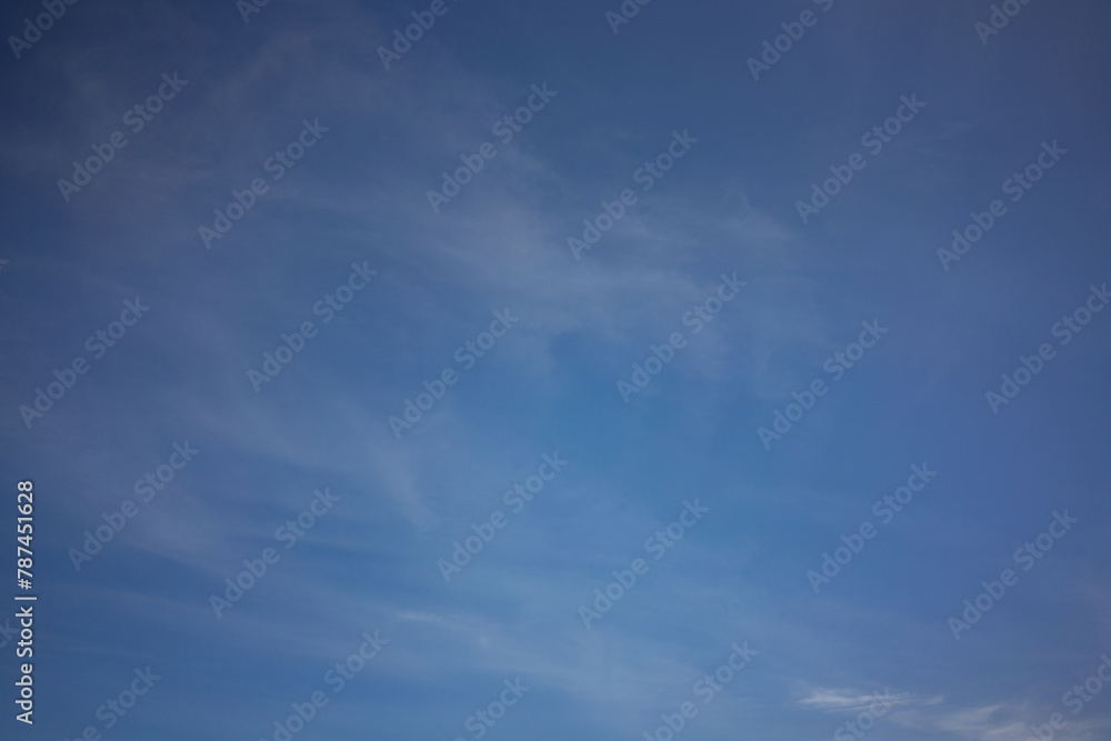 Serenity in the Sky: Blue Sky with Light, Wispy Clouds