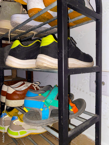 An array of casual shoes artfully arranged on a sleek metal shelf. UGC.