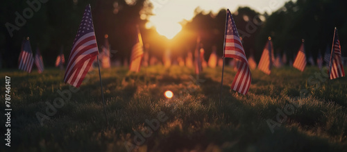 A field covered with American flags to honor fallen soldiers, with the rising sun gently lighting the scene and creating a visual tribute. Memorial Day, Independence Day , with copy photo