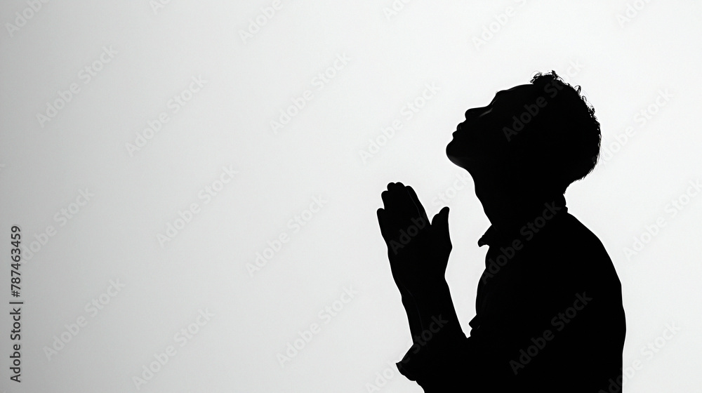 Silhouette of a men praying with copy space