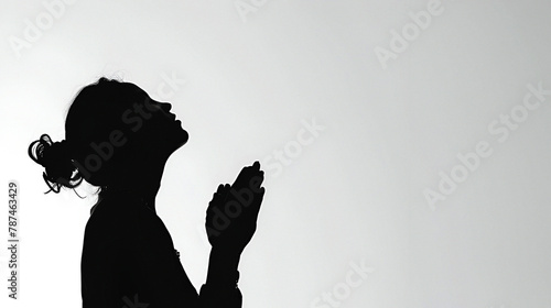 Silhouette of a women praying with copy space photo