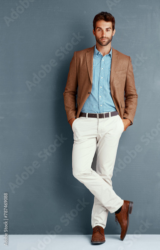 Business, style and portrait of man with designer clothes, creative career and professional in studio. Relax, trendy fashion and businessman on grey background with confidence, opportunity and pride