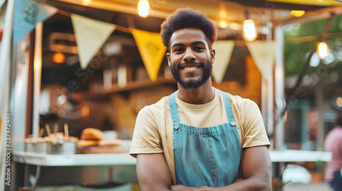 Portrait of smiling african american entrepreneur or Street food vendor standing with arms crossed in outdoor cafe.
