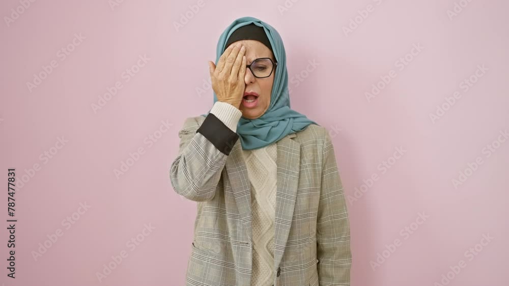 Tired middle-aged hispanic woman in hijab, sleepy yawn covering half her face with hand over isolated pink background, working late exhausted morning wakeup Tired middle-aged hispanic woman in hijab, sleepy yawn covering half her face with hand over isolated pink background, working late exhausted morning wakeup