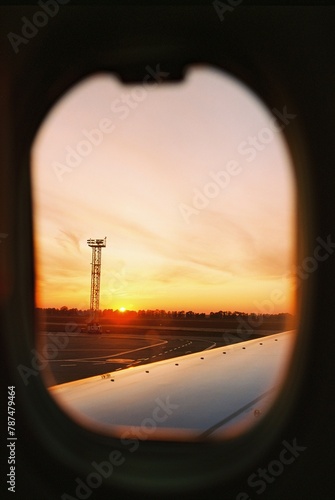 Sunset from an airplane window © PhotoPaliy