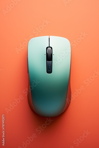 Computer mouse on orange background, Top view. photo