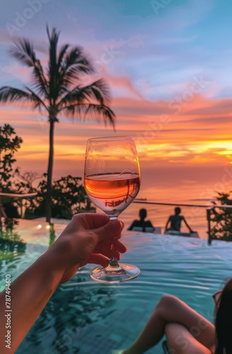 Person Holding Glass of Wine by Swimming Pool