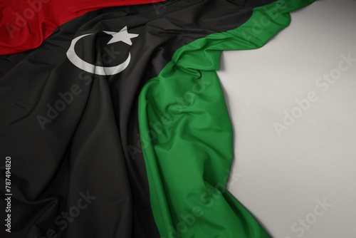 waving national flag of libya on a gray background. © luzitanija