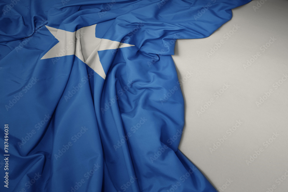 waving national flag of somalia on a gray background. waving national flag of somalia on a gray background.