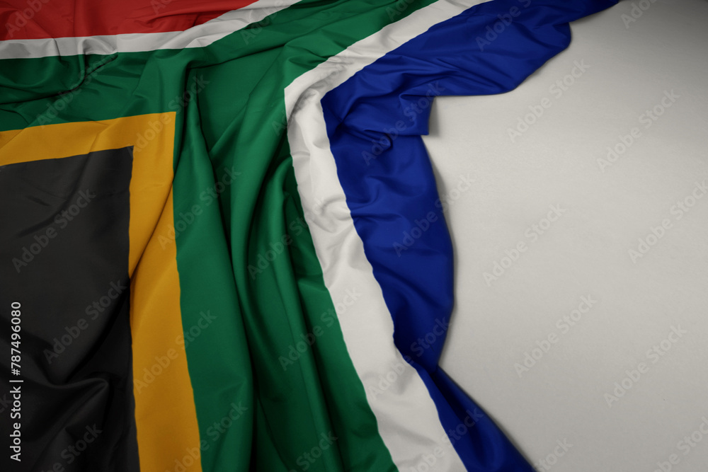 waving national flag of south africa on a gray background.