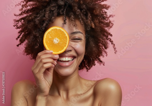 Woman Holding Orange Up to Face