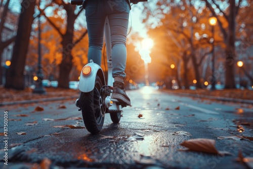An urban scene capturing a person's commute on an electric scooter through an autumn-coloured city at sunset