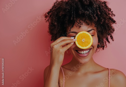 Woman Holding Orange in Front of Eyes