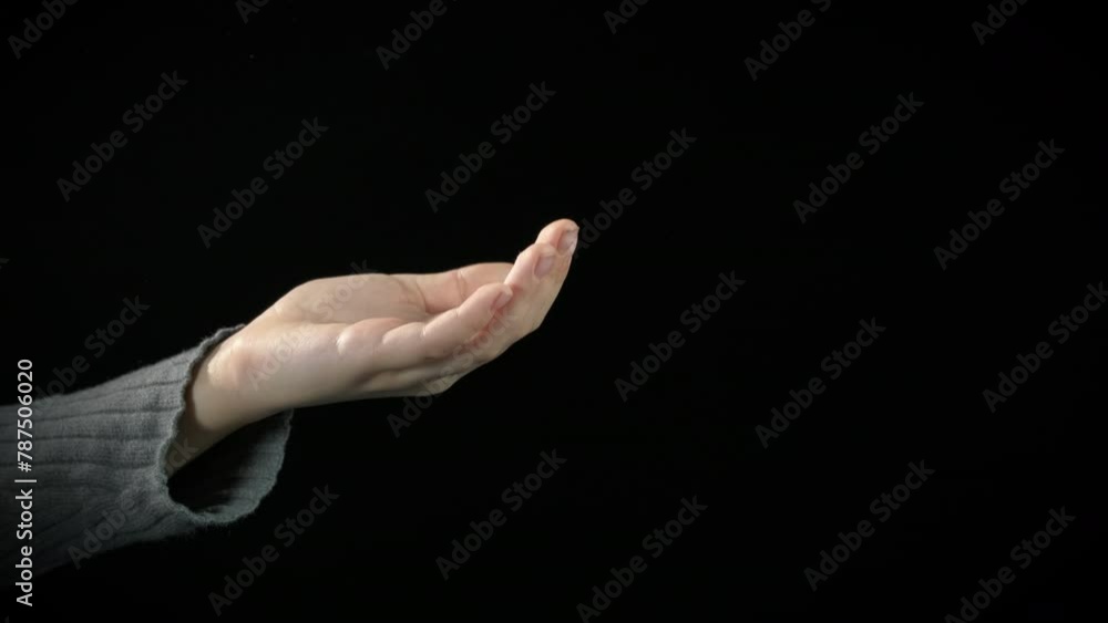 Little beggar need for food. A view of little beggar hand need for food against black background. Little beggar need for food. A view of little beggar hand need for food against black background.
