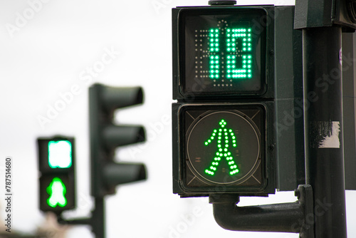 Green traffic light for pedestrians counting down in 10 seconds in Lisbon photo