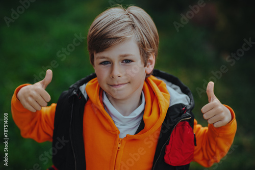 Portrait of handsome tourist boy giving thumbs up