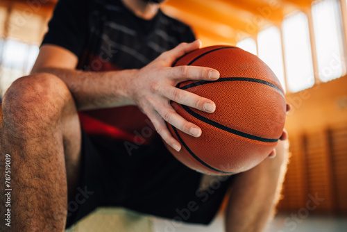 Close view of an unrecognized professional basketball player holding a ball