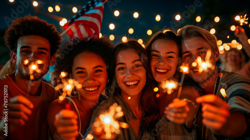 A group of funny friends celebrates the night with fireworks on the 4th of July, Independence Day in the United States