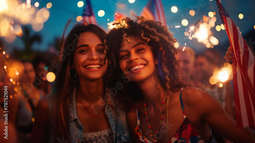 women Friends celebrating and enjoying the Independence Day in the United States on July 4th with fireworks
