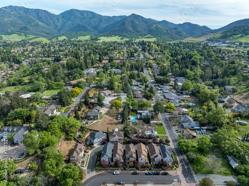 Drone landscape photos over the beautiful landscape of Clayton, California with homes, streets and green hills. photo