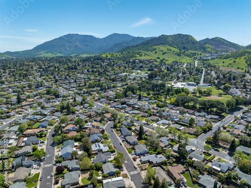 Aerial images over the beautiful landscape hills and communities in Clayton, California with green hills and homes photo