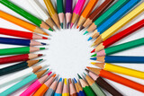 Circle of colored pencils with space for copying. School supplies.