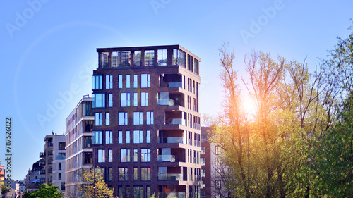 Eco architecture. Green tree and new residential building. Harmony of nature and modernity. Modern apartment building with new apartments in a green residential area.