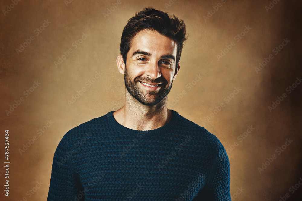 Fashion, portrait and smile with young man in studio on wall background for casual or trendy style. Clothes, face and jersey with confident or happy model in cardigan pullover for satisfaction Fashion, portrait and smile with young man in studio on wall background for casual or trendy style. Clothes, face and jersey with confident or happy model in cardigan pullover for satisfaction