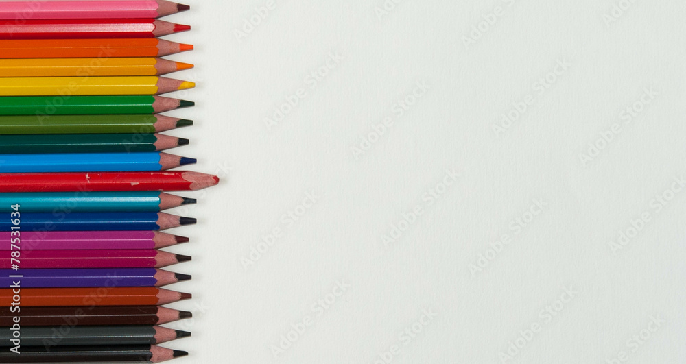 Row of bright coloured pencils with one old pencil Row of bright coloured pencils with one old pencil