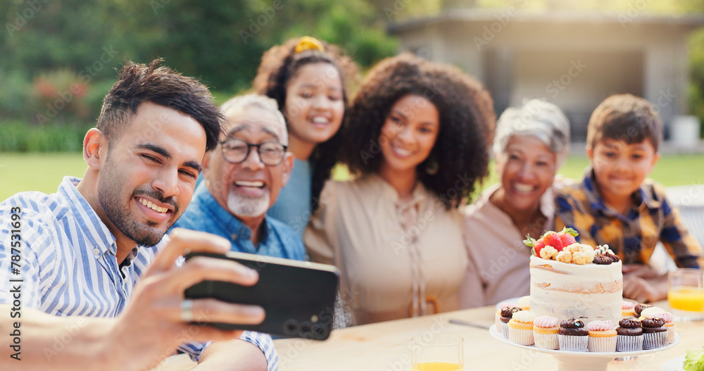 Obraz premium Selfie, family and birthday in backyard with happy, social media and grandparents outdoor. Home, smile and table with celebration and party cake in garden with parents and kids with love and food