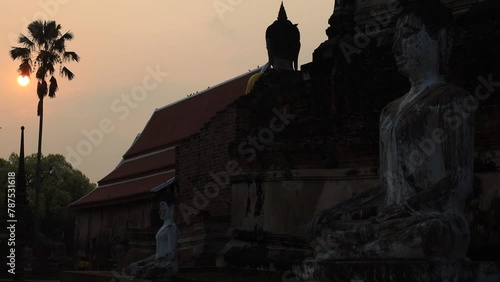 The background of the video is of the evening sun falling on an ancient ancient site in Ayutthaya, Thailand. Wat Chaiwatthanaram Wat Yai Chai Mongkol It is ancient and worth studying its history. photo
