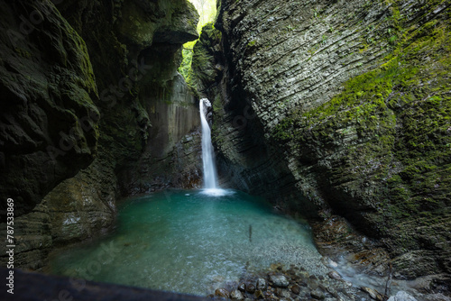 Caporetto, Slovenia. Kozjak waterfalls. Nature trail along the river with crystal clear, turquoise water, Tibetan bridges and a waterfall inside the cave with a nature pool. easy trekking, wood path.