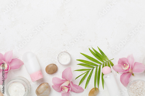 Composition with orchids, spa products on concrete background, top view