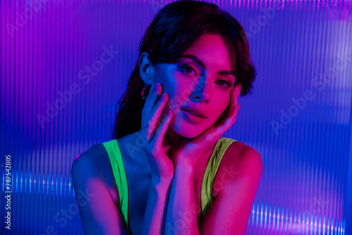 Photo of girl touch fingers glowing facial skin look over futurism background isolated neon color