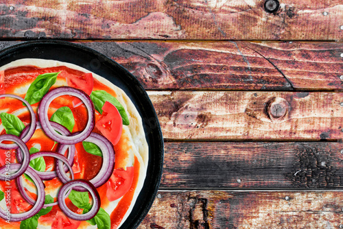 Pizza in a Pan with Wooden Background