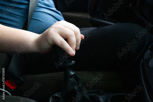 Hand on gear lever and car. Driver's hand. © Robert