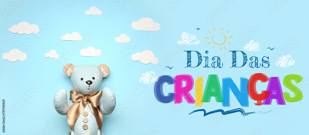 Naklejka premium Toy bear with paper clouds on blue background