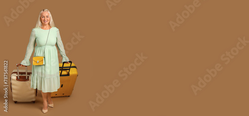 Senior woman with suitcases...