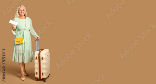 Senior woman with suitcase ...