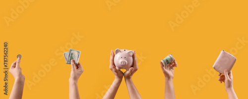 Women with money, piggy bank and wallet on yellow background