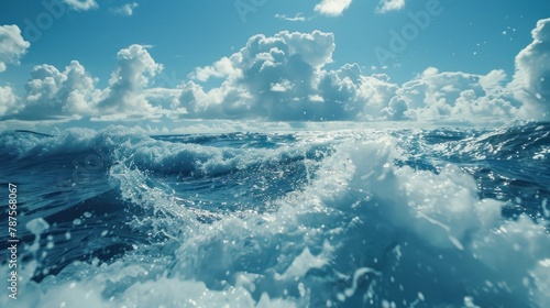 Beautiful sea waves surface with rolling and splashing foamy on white cloudy blue sky background. © MUCHIB