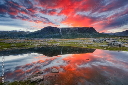 Mountain range reflected in the lake in evening mood with red clouds, Gaellivare, Norrbottens laen, Sweden, Europe photo