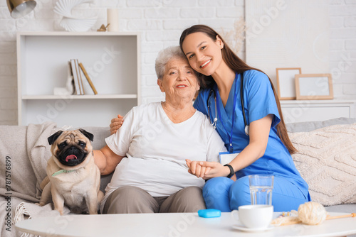 Senior woman with pug dog a...