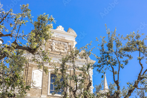 church facade at Square with monument for fallen soldiers in first world war in the centre of Brindisi, Puglia, Italy, on a warm summer day © Anze