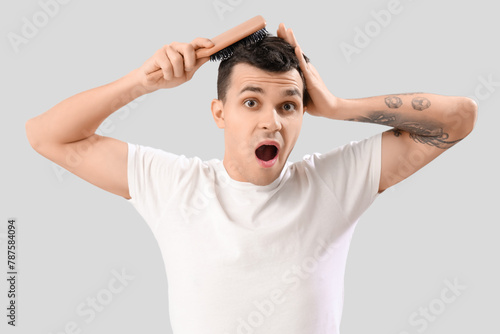 Shocked young man with hair...