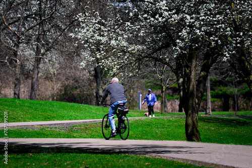 People out and about on a very warm April day in Upstate NY.  Otsiningo Park in Binghamton was busy with visitors walking, sitting and biking its paved trails.  Two elderly men, riding & walking.